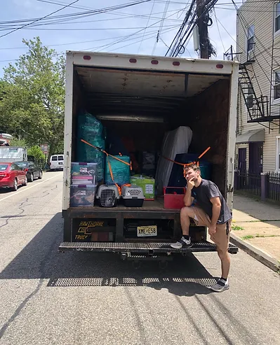 Twins Moving Service professional mover with a fully loaded truck