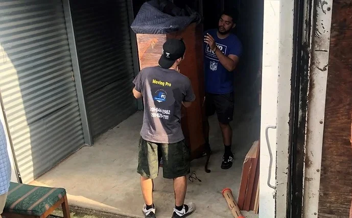 Twins Moving Service team members carefully moving furniture